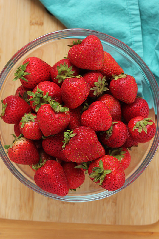 glass bowl filled with fresh strawberries