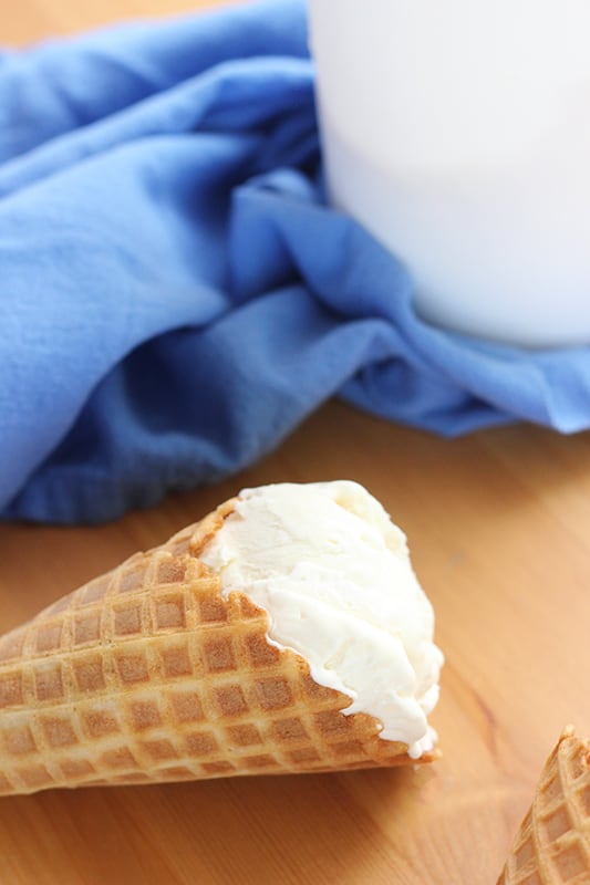 vanilla ice cream in waffle cone on table