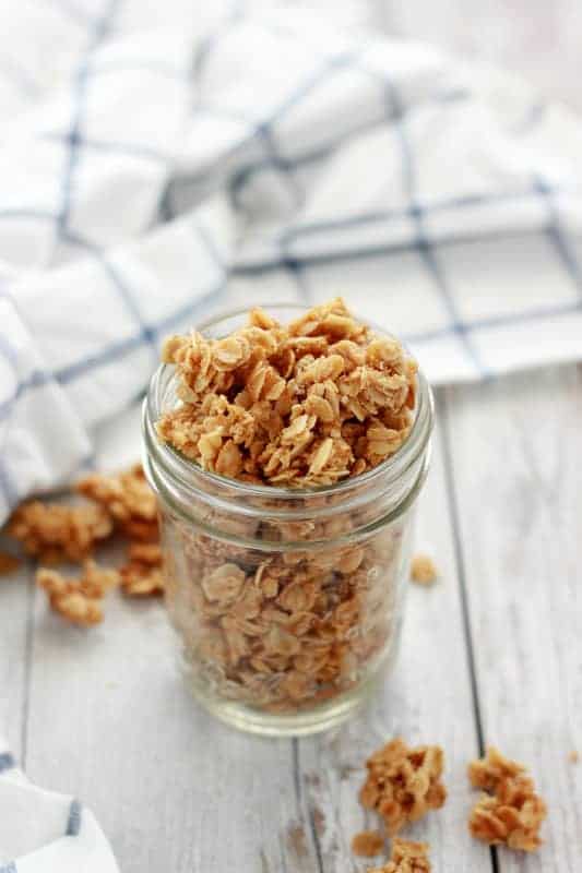 Granola in a mason jar with pieces spilling out