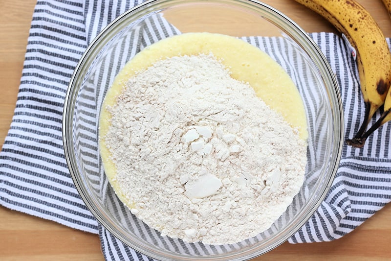 dry ingredients poured on top of wet ingredients in a mixing bowl