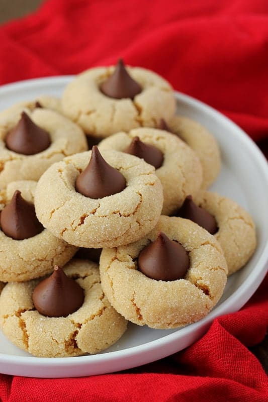 White plate filled with peanut butter cookies topped with chocolate candies