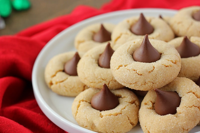 stack of peanut butter cookies with Hershey Kiss candies on top