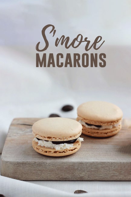 Featured image of two cookies that are filled with marshmallow filling and chocolate ganache on a wooden plank with a white background