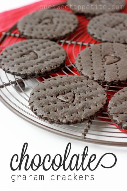 round cooling rack lined with chocolate cookies that have hearts cut into the center of each