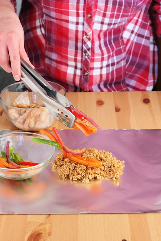 stacking peppers on top of a foil dinner