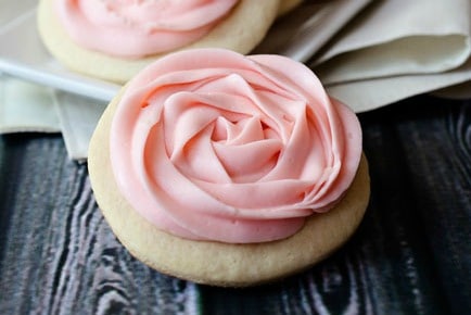 sugar cookie with pink frosting pipped like a flower