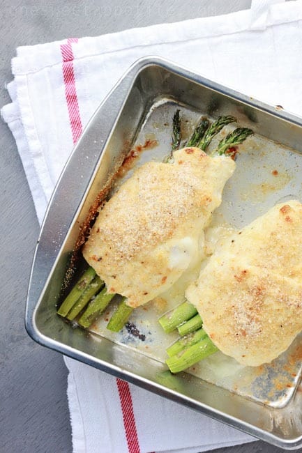 pan filled with baked chicken and asparagus