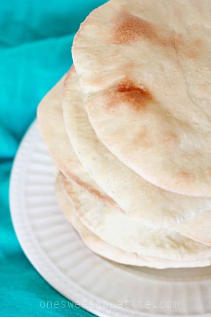 stack of homemade pita bread on a white plate