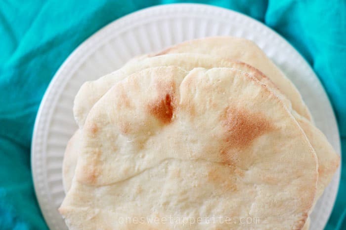 Pita bread stacked onto a plate