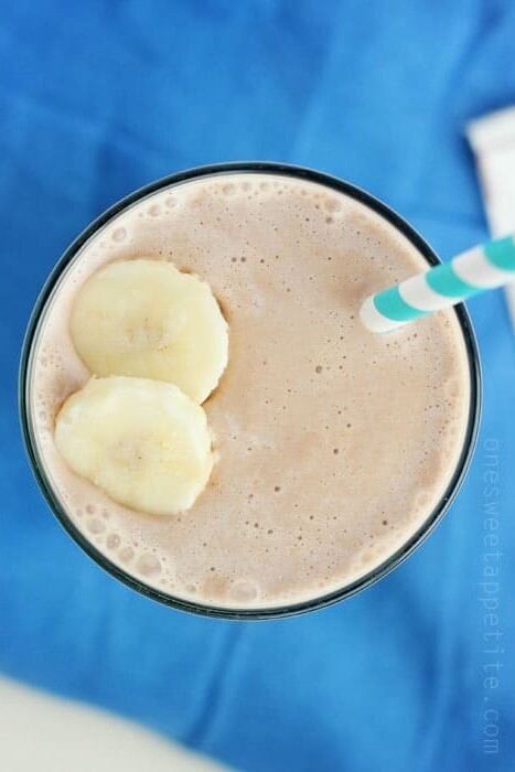 top down image of a chocolate peanut butter smoothie with banana slices on top