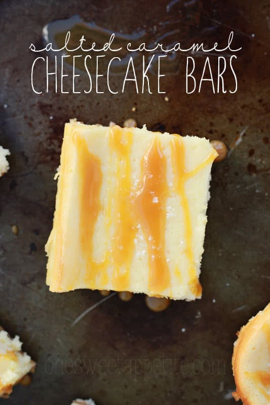 top down image showing a single cheesecake bar that has been drizzled with caramel sauce. The bar is sitting on a dark tin pan and there is text overlay reading "salted caramel cheesecake bars"
