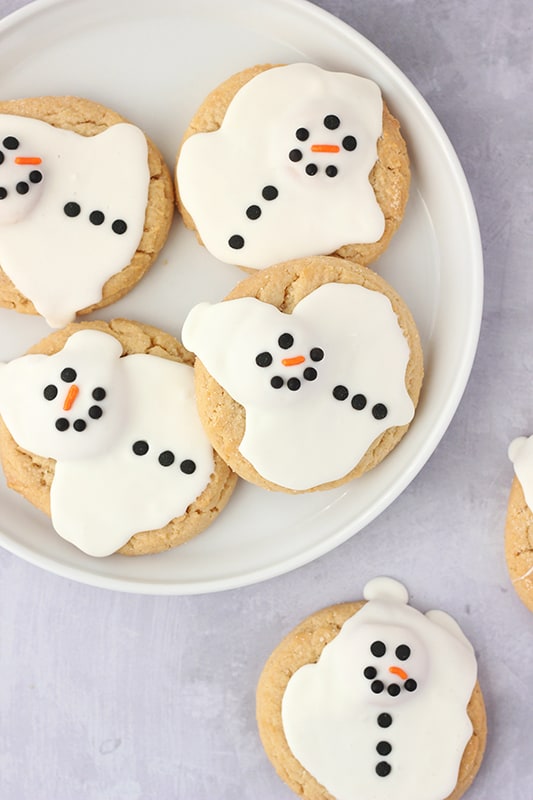 white plate full of snowman cookies