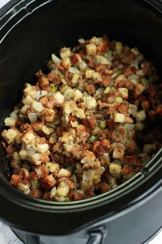 Slow cooker filled with cooked stuffing