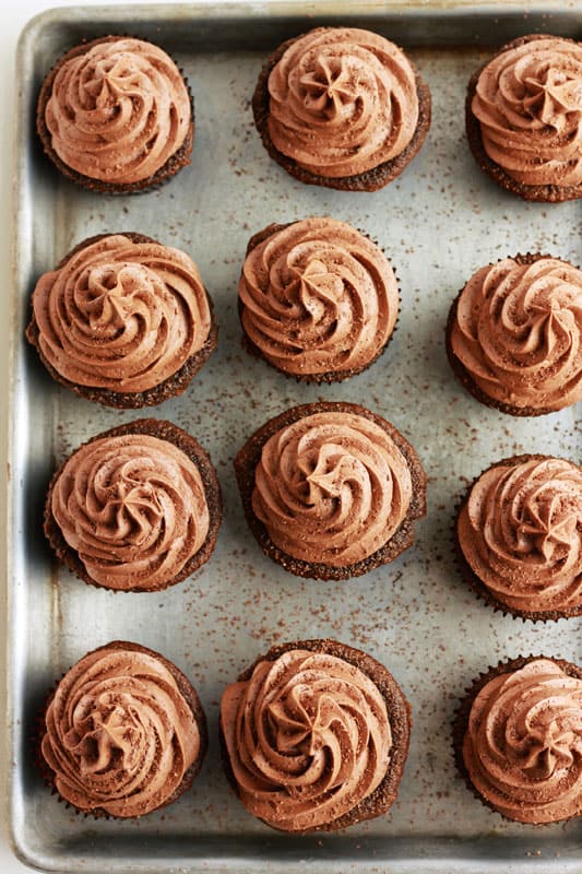 TOP DOWN IMAGE OF CHOCOLATE CAKES WITH PIPED FROSTING
