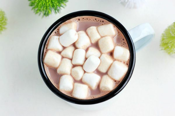 top down image of a white mug filled with cocoa and mini marshmallows