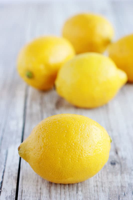 fresh lemons on a wooden tabletop 