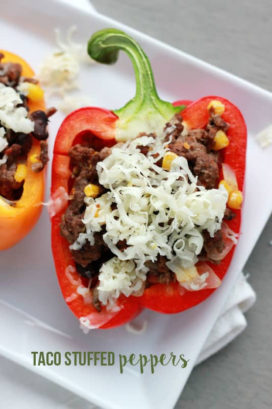 Top down image of a white plate lined with stuffed peppers