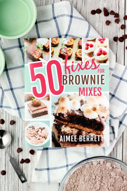 50 Fixes for Brownie Mixes cookbook sitting on a white wooden tabletop