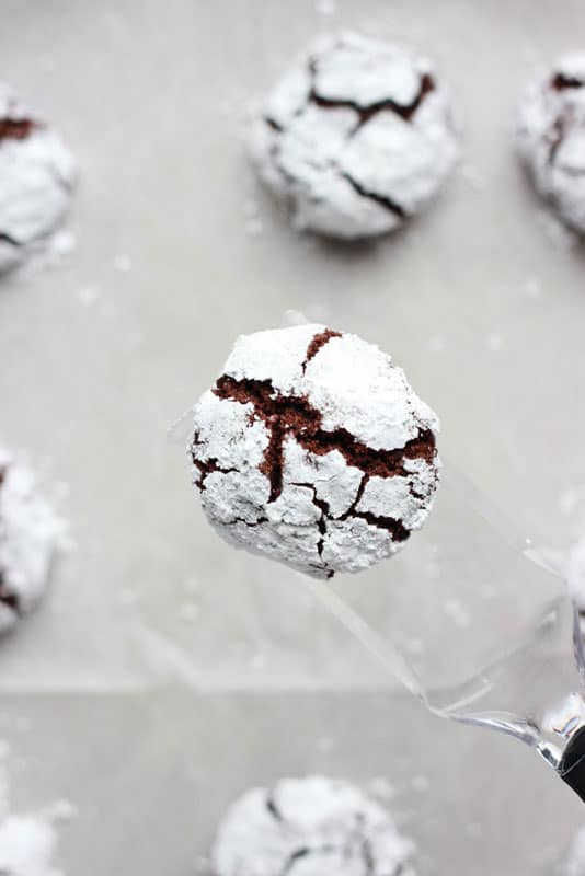 Cookie held on clear spatula above baking tray