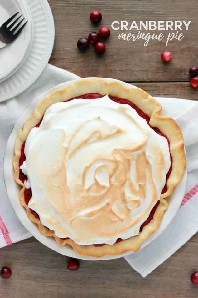 meringue topped cranberry pie on a wooden table top
