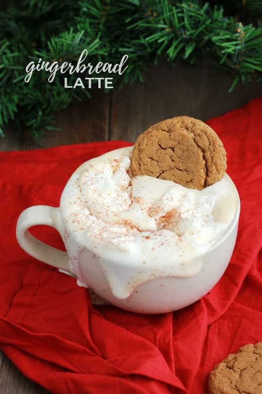 latte topped with whipped cream and a fresh ginger cookie