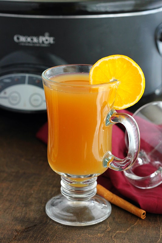 glass filled with cider and an orange slice