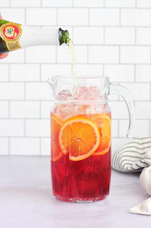 apple cider being poured into pitcher