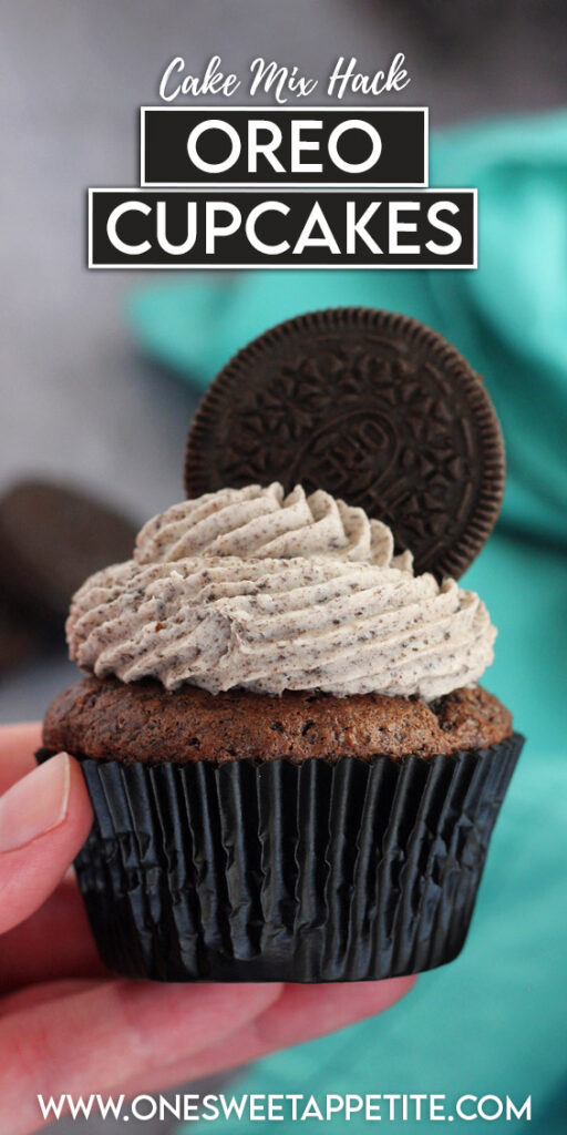 pinterest graphic image of a single cupcake that is being held with a hand and topped with speckled frosting and an oreo cookie. Text overlay reads "cake mix hack oreo cupcakes"