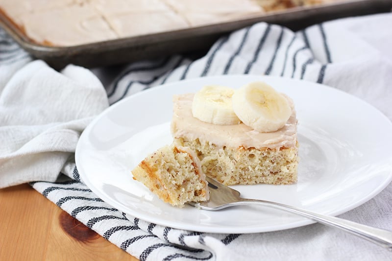 banana bar on a white plate with a bite sitting to the side on a fork