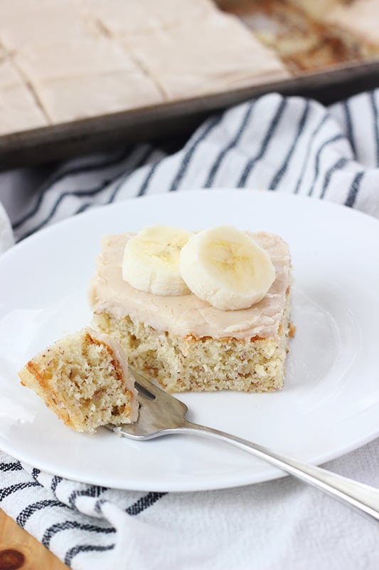 banana bar on a white plate with a bite sitting to the side on a fork