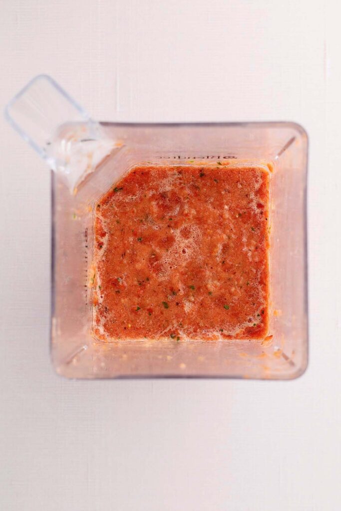 Top down showing the insider of a blender with salsa