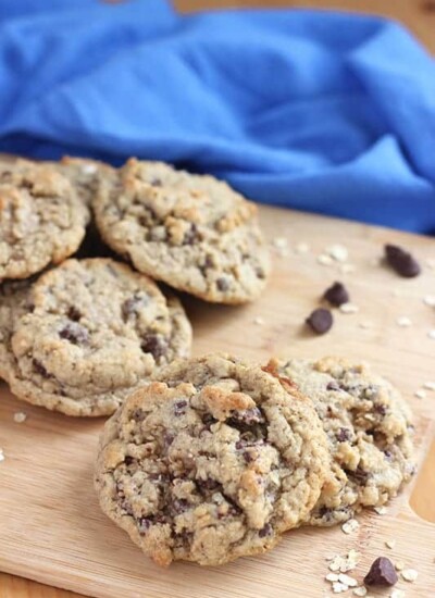 oatmeal chocolate chip cookies on cutting board with blue napkin