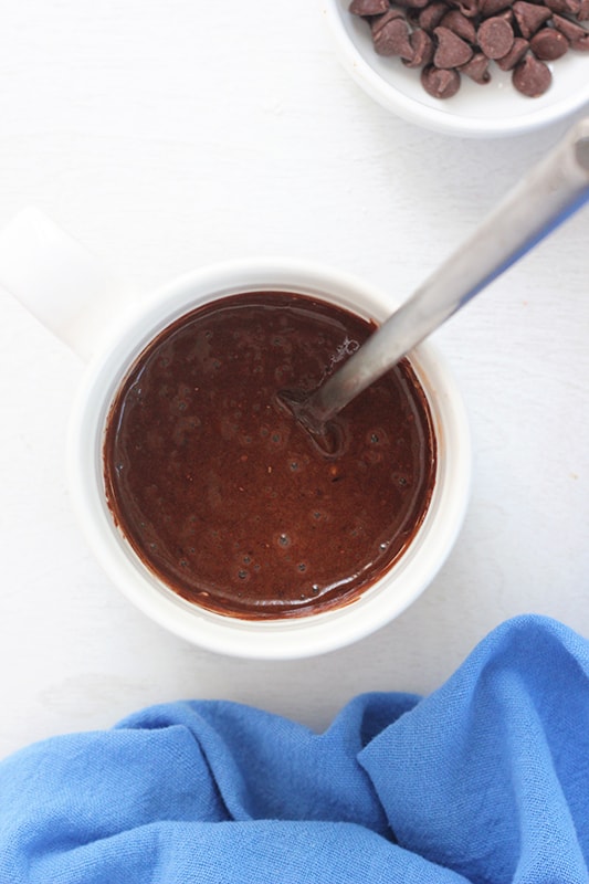 chocolate cake batter in mug with fork