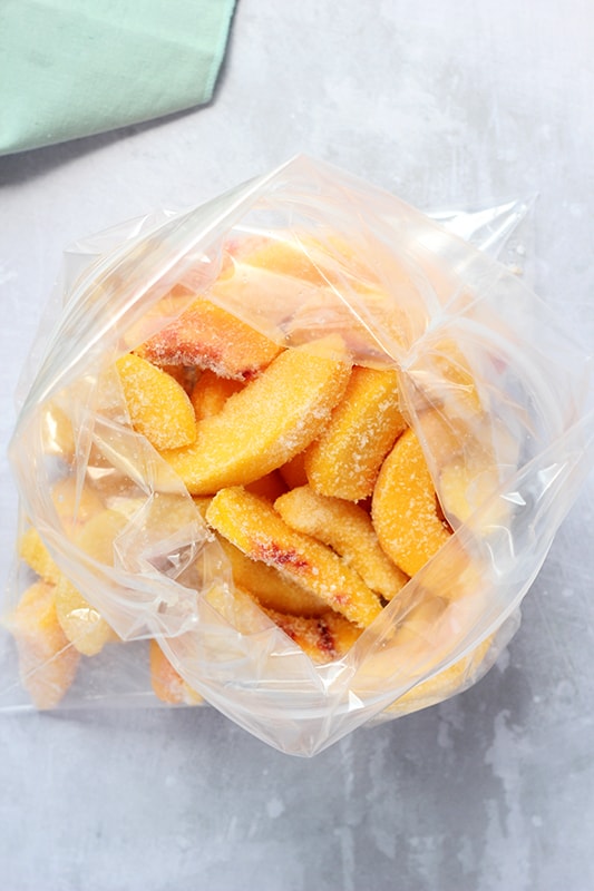 open zip top bag showing frozen sliced peaches