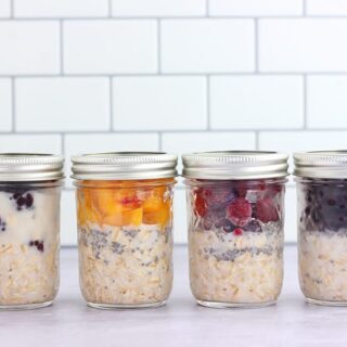 Overnight oats lined in mason jars on a white counter