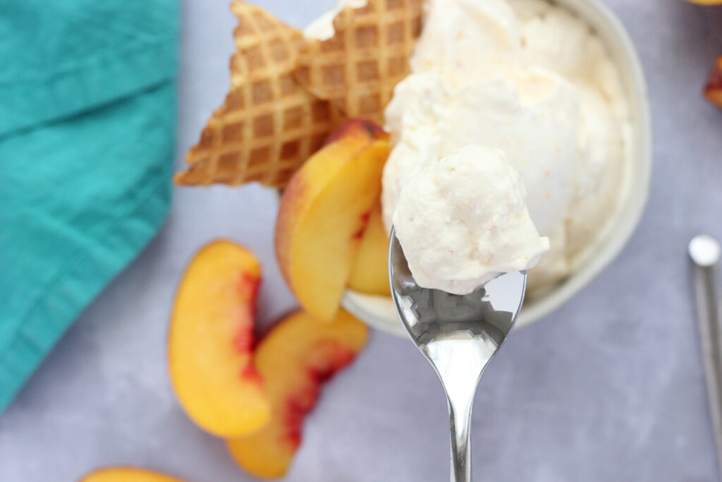peach ice cream on a spoon