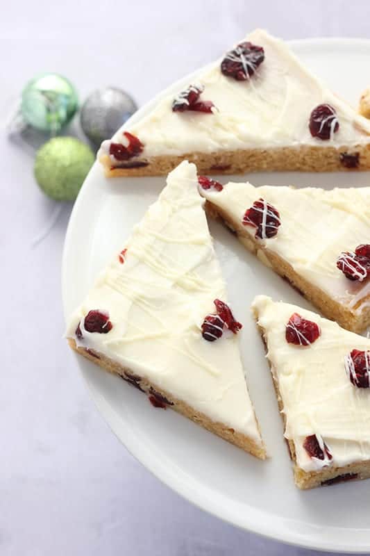 Copycat Cranberry Bliss Bars on a white cake stand