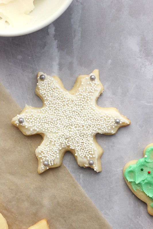Sugar Cookie shaped like snowflake with white sprinkles