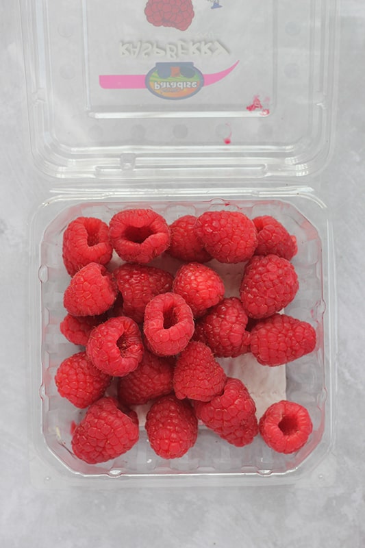 fresh raspberries in their container