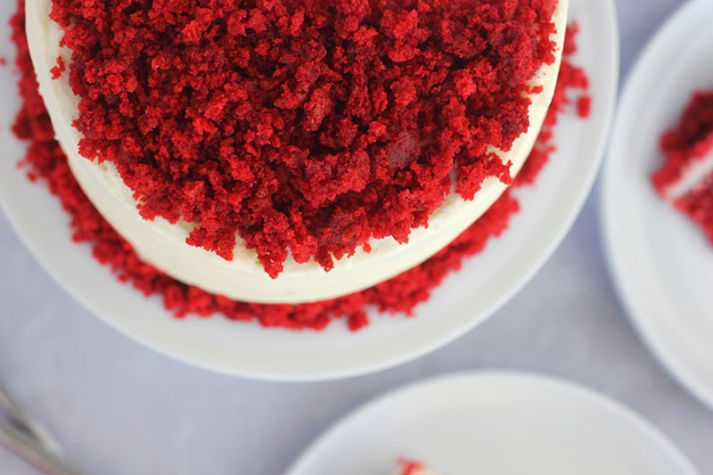 Top down photo of red velvet cake with cake crumbs