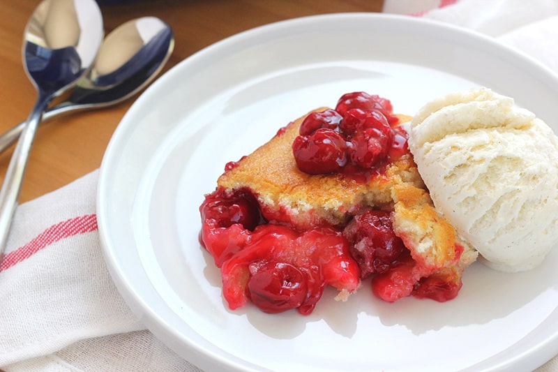 Cherry Cobbler Recipe on a white plate with vanilla ice cream