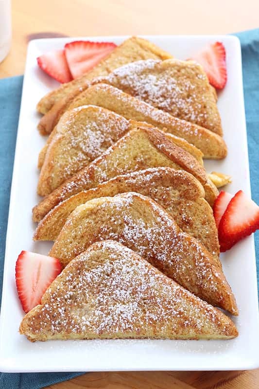 Layers of cinnamon french toast on a plate with strawberries