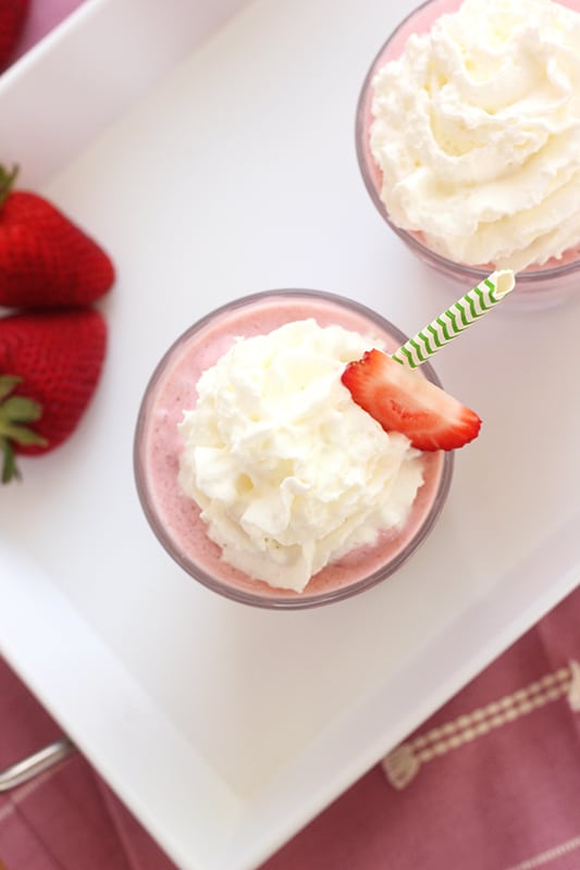 Top down photo of strawberry frappe with whipped cream and strawberry