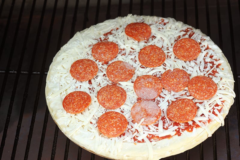 Frozen pepperoni pizza on the grill