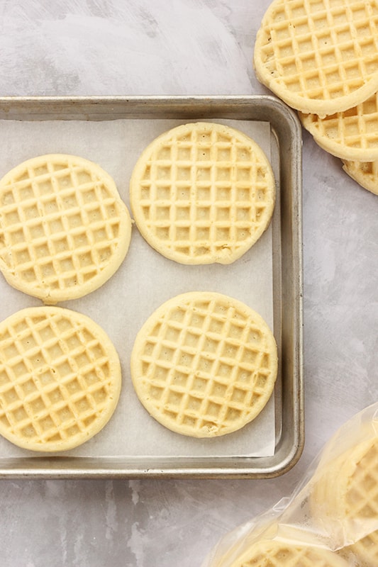 Waffles lined on a baking sheet ready to be toasted