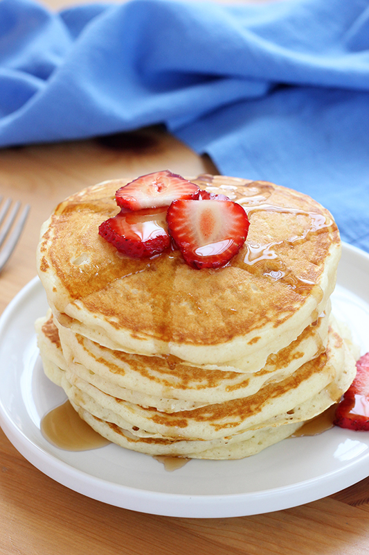 stack of buttermilk pancakes on a white plate