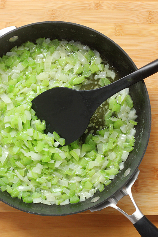 Cooked onion and celery in a pan