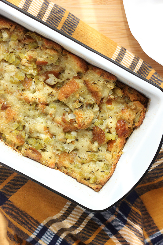 Bread pan with stuffing on a plaid towel