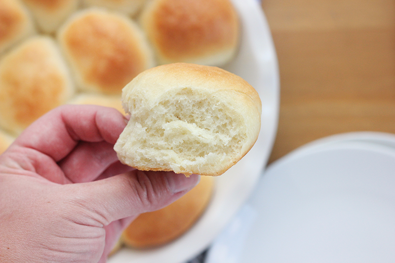 homemade dinner roll held in a hand