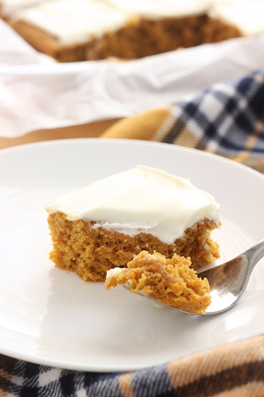 Pumpkin bar on a white plate with a bite on a fork